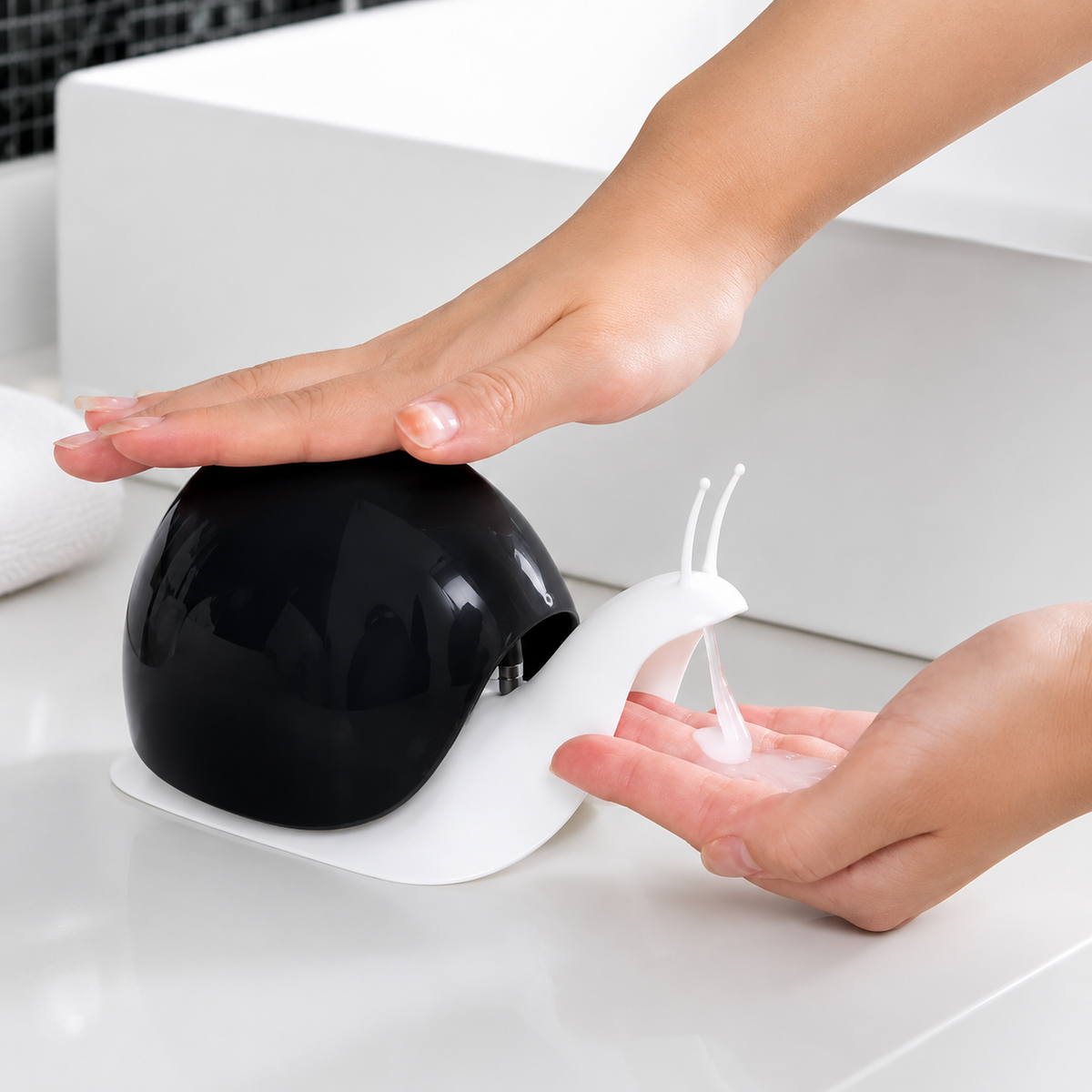 Cartberry black snail shape soap dispenser in use